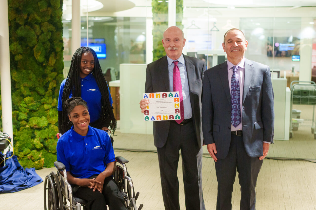 Council Chairman Phil Mendelson and Michael Rodrigues with two students.